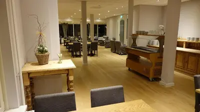 a waiting room with a table and chairs at Hotel Golfzicht in Noordwijk aan Zee