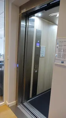 an elevator in an office building with a glass door at Hotel Golfzicht in Noordwijk aan Zee