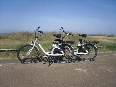 two bikes parked next to each other on a road at Hotel Golfzicht in Noordwijk aan Zee
