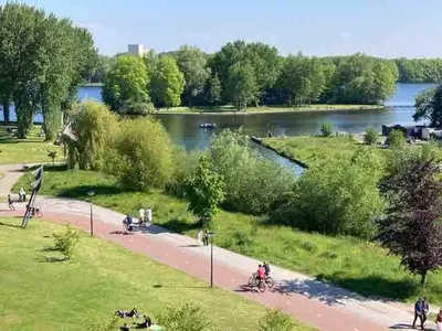 a park with a body of water and a river at Spacious and Cozy House with Affordable Parking in Amsterdam