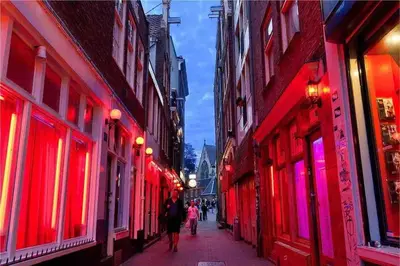 a group of people walking down a street with red lights at Spacious and Cozy House with Affordable Parking in Amsterdam