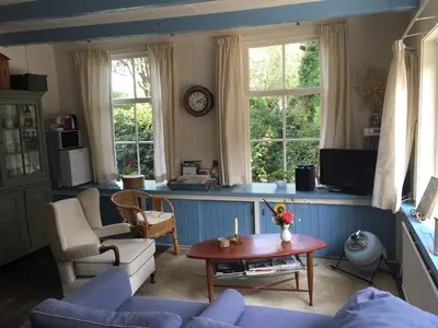 a living room with a couch and a table at Droomgaerd in Vlist