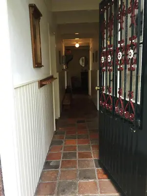 a hallway with a black door and a tile floor at Droomgaerd in Vlist