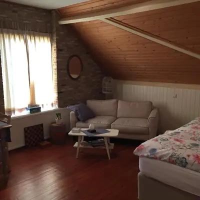 a living room with a couch and a table at Droomgaerd in Vlist