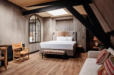a bedroom with a bed and a table and chairs at City Center Lodge Utrecht in Utrecht