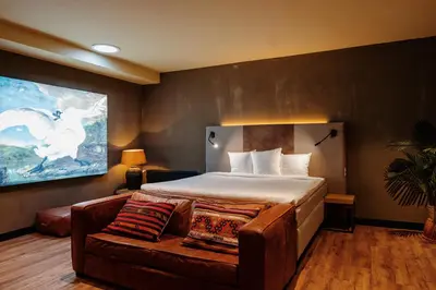 a hotel room with a bed and a couch at City Center Lodge Utrecht in Utrecht
