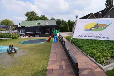 a sign in front of a park with a playground at Guest House Aan de Hollandse IJssel in Montfoort