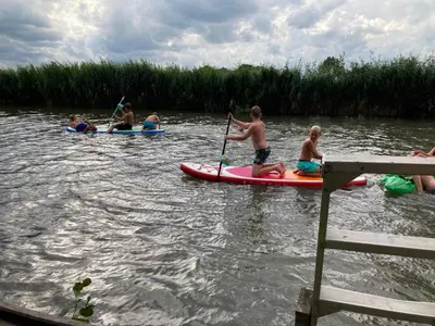 a group of people kayaking on a river at Guest House Aan de Hollandse IJssel in Montfoort