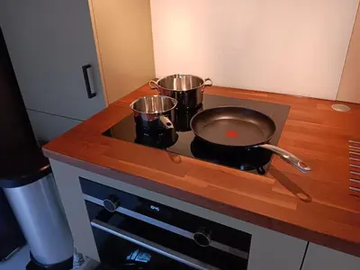 a stove top with two pots and a pan on it at Guesthouse Voorhout in Voorhout
