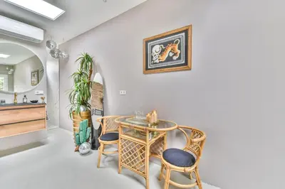 a dining room with a table and chairs at Pats garden room with mini cinema, projector in Alkmaar