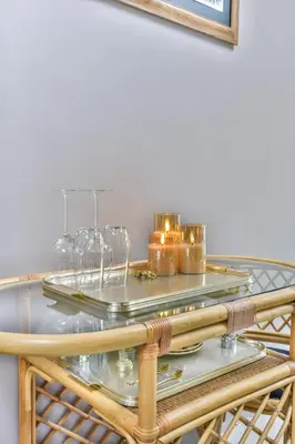 a glass table with wine glasses and candles on it at Pats garden room with mini cinema, projector in Alkmaar