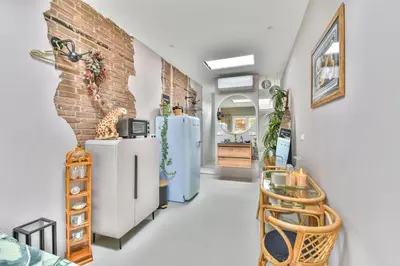 a room with two refrigerators and a brick wall at Pats garden room with mini cinema, projector in Alkmaar