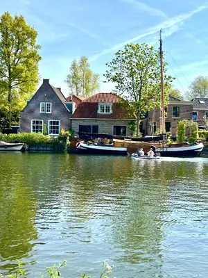 a couple of people in a boat on a river at Ray's crew in Weesp