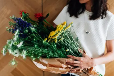 a woman is holding a bouquet of flowers at Boutique B&B Bovien in Amsterdam