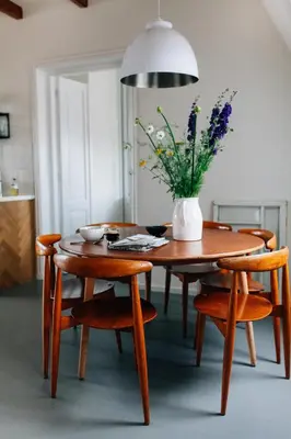 a dining room table with a vase of flowers on it at Boutique B&B Bovien in Amsterdam
