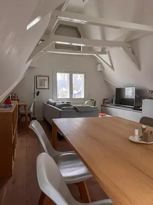 a living room with a large wooden table and chairs at New V Luxury Apartment in Amsterdam