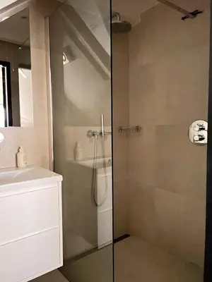 a bathroom with a shower and a sink at New V Luxury Apartment in Amsterdam
