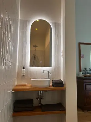 a bathroom with a sink and a mirror at In de Pastorie Utrecht - Old rectory, just steps away from the city center in Utrecht