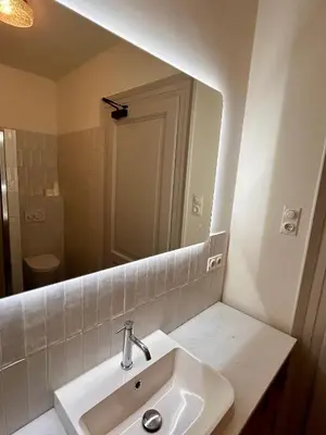 a bathroom with a sink and a large mirror at In de Pastorie Utrecht - Old rectory, just steps away from the city center in Utrecht