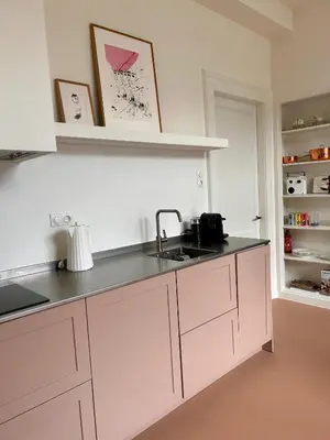 a kitchen with white cabinets and a sink at In de Pastorie Utrecht - Old rectory, just steps away from the city center in Utrecht