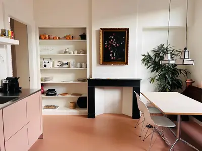 a dining room with a desk and a table at In de Pastorie Utrecht - Old rectory, just steps away from the city center in Utrecht