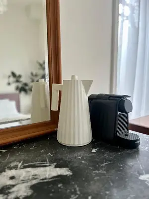 a mirror and a lamp sitting on the floor in a room at In de Pastorie Utrecht - Old rectory, just steps away from the city center in Utrecht