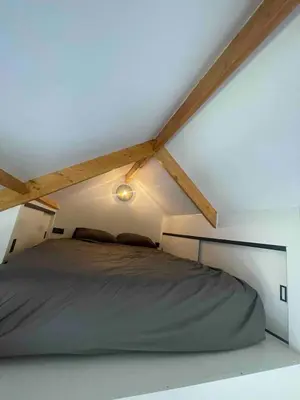 a bed in a white room with a ceiling at Unique Lodge 22 min from Amsterdam CS in Westzaan