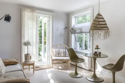 a living room with a couch and a table and chairs at Palm Tree in Bergen