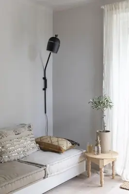 a bedroom with a bed with a lamp and a table at Palm Tree in Bergen