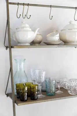 a shelf with dishes and glasses on it at Palm Tree in Bergen