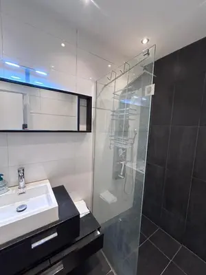 a bathroom with a glass shower and a sink at Gezellig Appartement in Amsterdam-Noord in Amsterdam