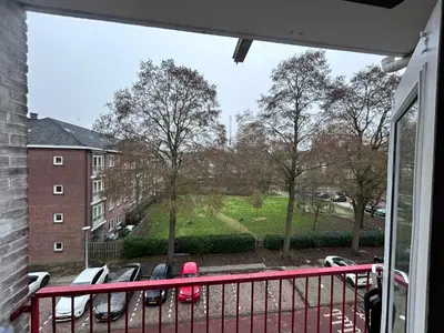 a child standing on a balcony looking out of a window at Gezellig Appartement in Amsterdam-Noord in Amsterdam
