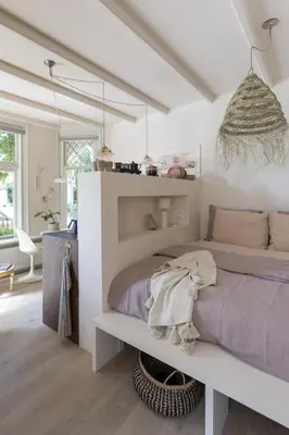 a white bedroom with a bed and a table at Magnolia Tree in Bergen