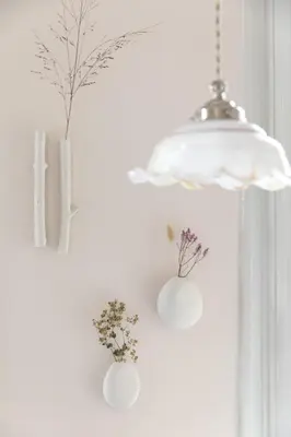 two vases with flowers in them hanging on a wall at Magnolia Tree in Bergen