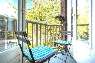 a porch with a chair and a table and a window at Beautiful quiet Apt in the center of Amsterdam in Amsterdam