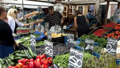 a group of people at a farmers market with vegetables at Beautiful quiet Apt in the center of Amsterdam in Amsterdam