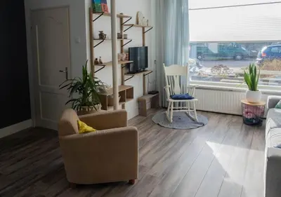 a living room with a couch and a chair at Family beach house in Egmond aan Zee