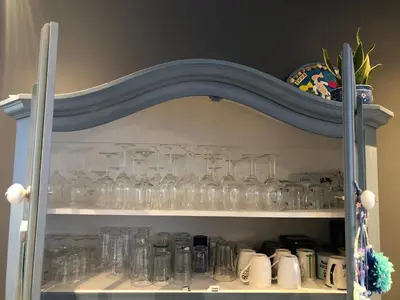 a cabinet filled with glasses on a shelf at Family beach house in Egmond aan Zee