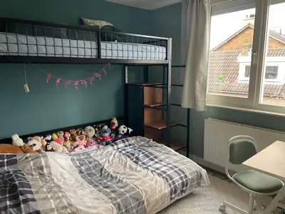 a group of stuffed animals sitting on top of a bed at Family beach house in Egmond aan Zee