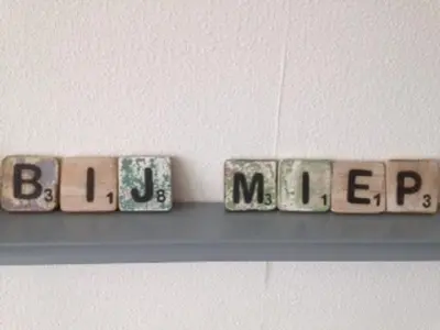 a shelf with blocks that spell out the wordchecked at bij Miep in Egmond aan Zee