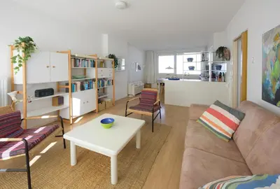 a living room with a couch and a table at de Vloedlijn in Egmond aan Zee