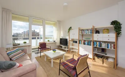 a living room with a couch and a table at de Vloedlijn in Egmond aan Zee