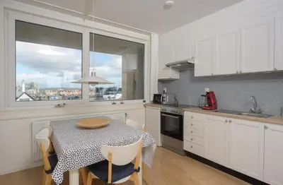 a kitchen with a table with a table cloth on it at de Vloedlijn in Egmond aan Zee