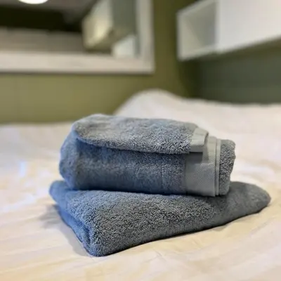 a pile of towels sitting on top of a bed at Nice chalet near Reeuwijkse plassen in Reeuwijk