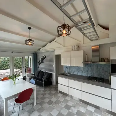 a kitchen and living room with a white table at Nice chalet near Reeuwijkse plassen in Reeuwijk