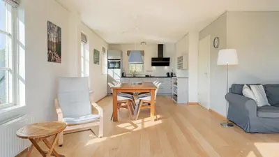 a living room with a table and a couch at De Zeemeeuw in Schoorl