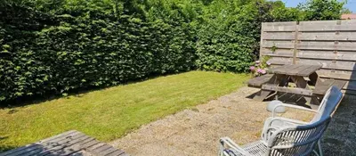 a picnic table and a bench in a yard at Rekerlanden 153 in Schoorldam