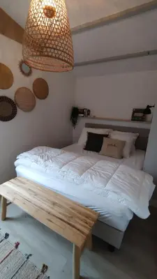 a bedroom with a bed and a pendant light at Rekerlanden 153 in Schoorldam