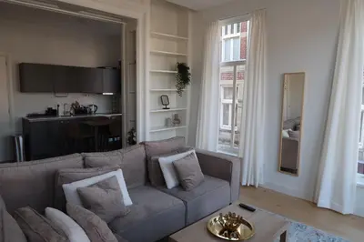 a living room with a couch and a table at Appartement Rokin in Amsterdam