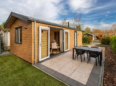 a small house with a table in the backyard at Rekerlanden 260 in Schoorldam